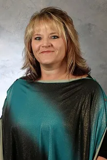 Stephanie Hanenberg wearing a teal and black shirt against gray background